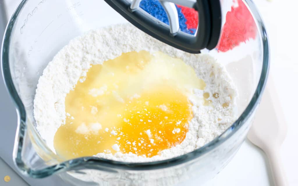 cake mix and eggs with oil in a stand mixer bowl
