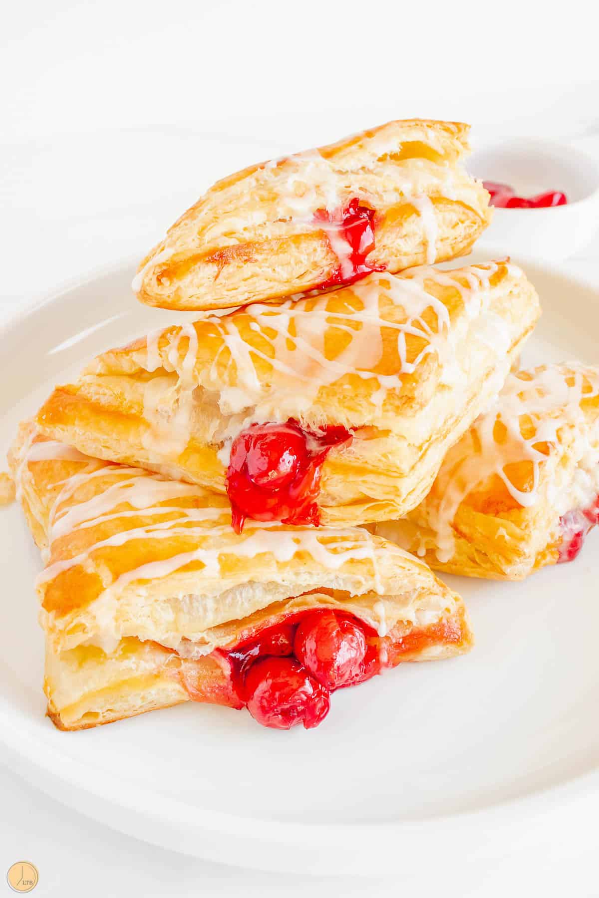 stack of cherry turnovers on a white plate