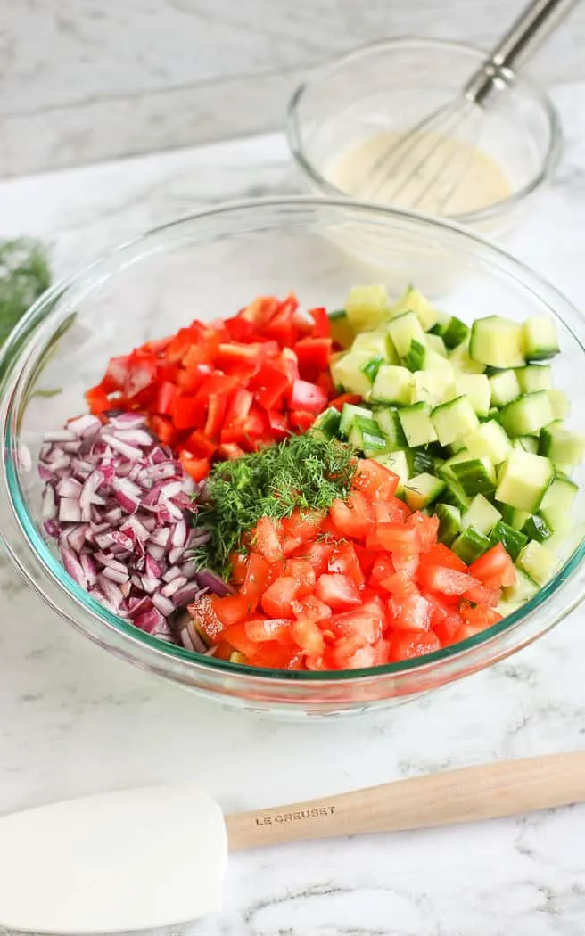 chopped veggies in a clear bowl with no dressing