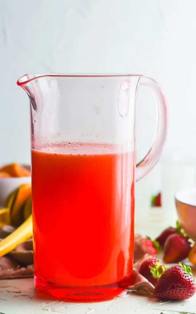 glass pitcher of strawberry lemonade