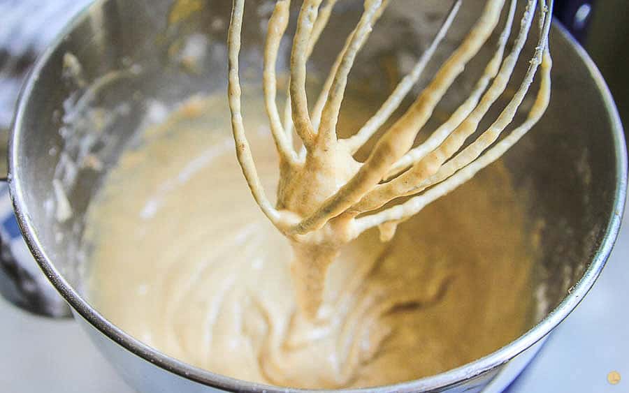 banana bread batter dripping from a whisk