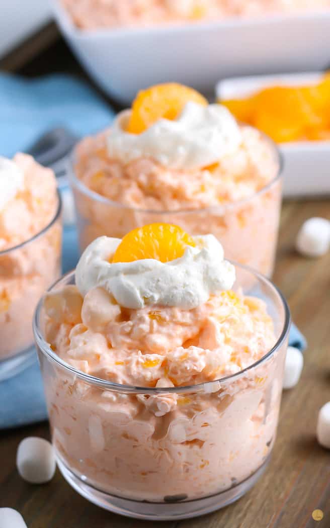 close up of orange jello salad in a clear bowl