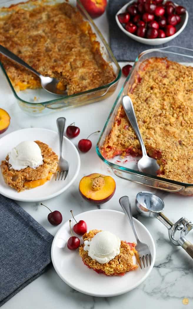 two dishes of cake with plates topped with ice cream