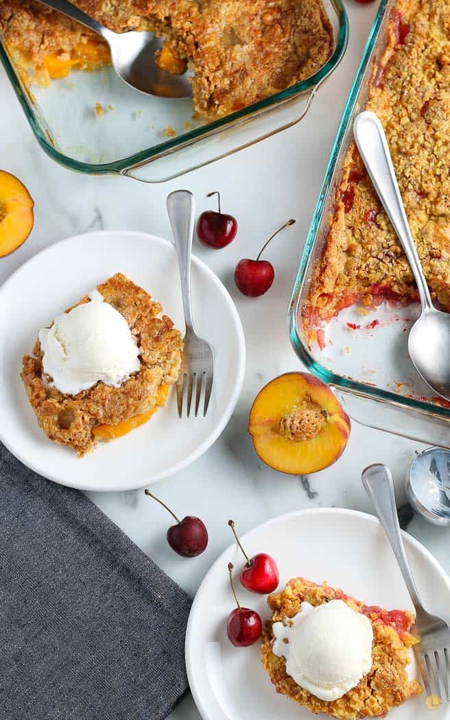 two plates of dump cake with fresh fruit garnish