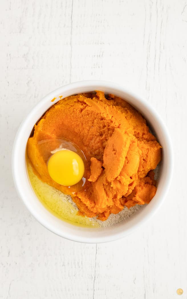 pumpkin puree in a white bowl with egg