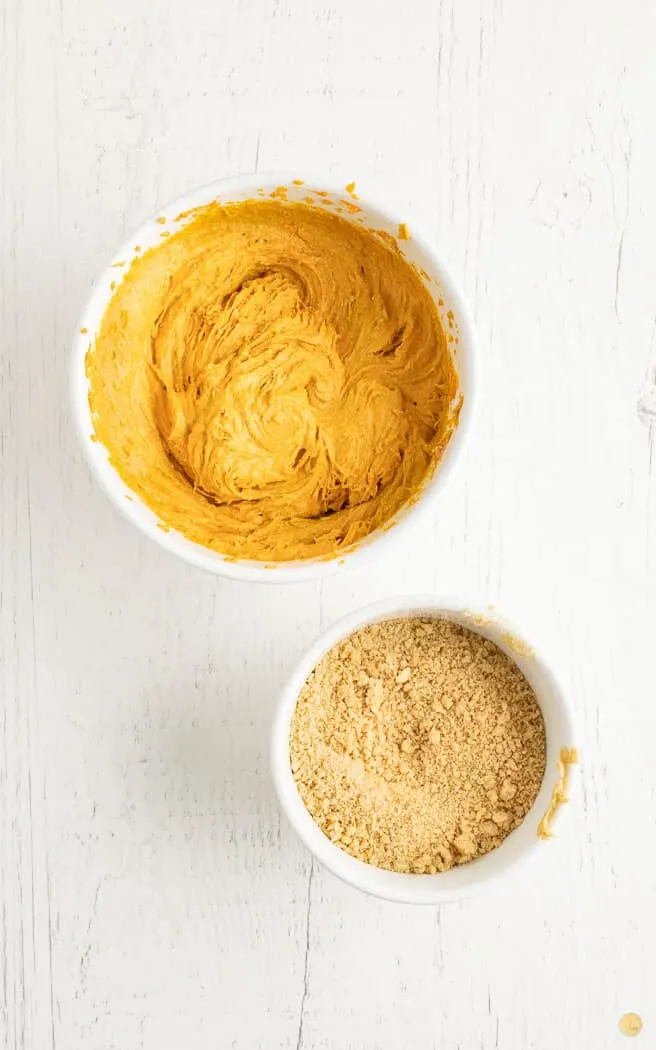 two bowls of pumpkin bread batter and streusel topping
