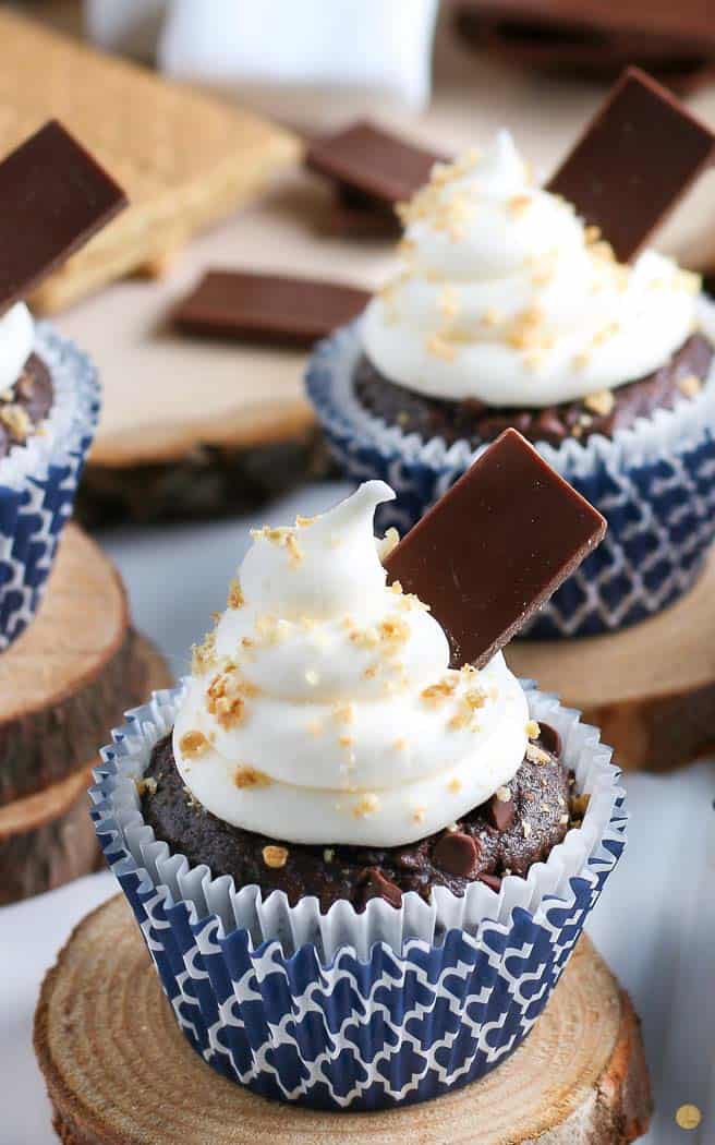 smores cupcake in a blue wrapper on a wood board