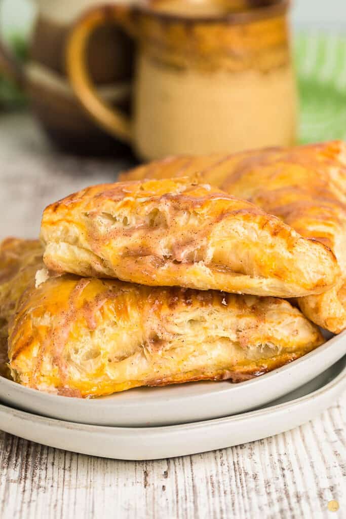 two turnovers on a stack of grey plates