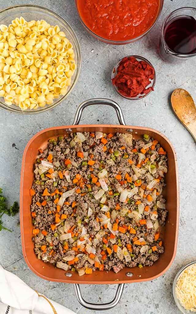cooked beef and aromatics in a square pan