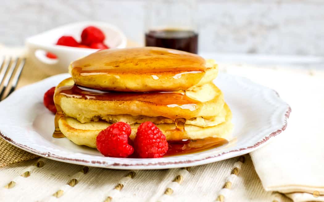 side view of stack of pancakes with berries