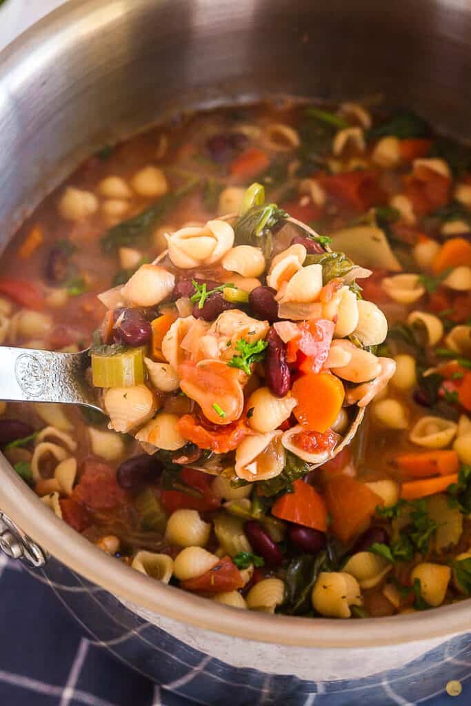 close up of ladle full of soup