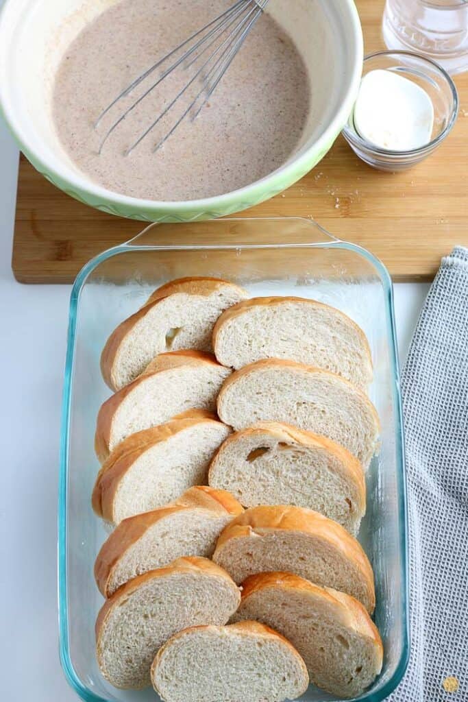 slices of bread lined up in a clear baking dish
