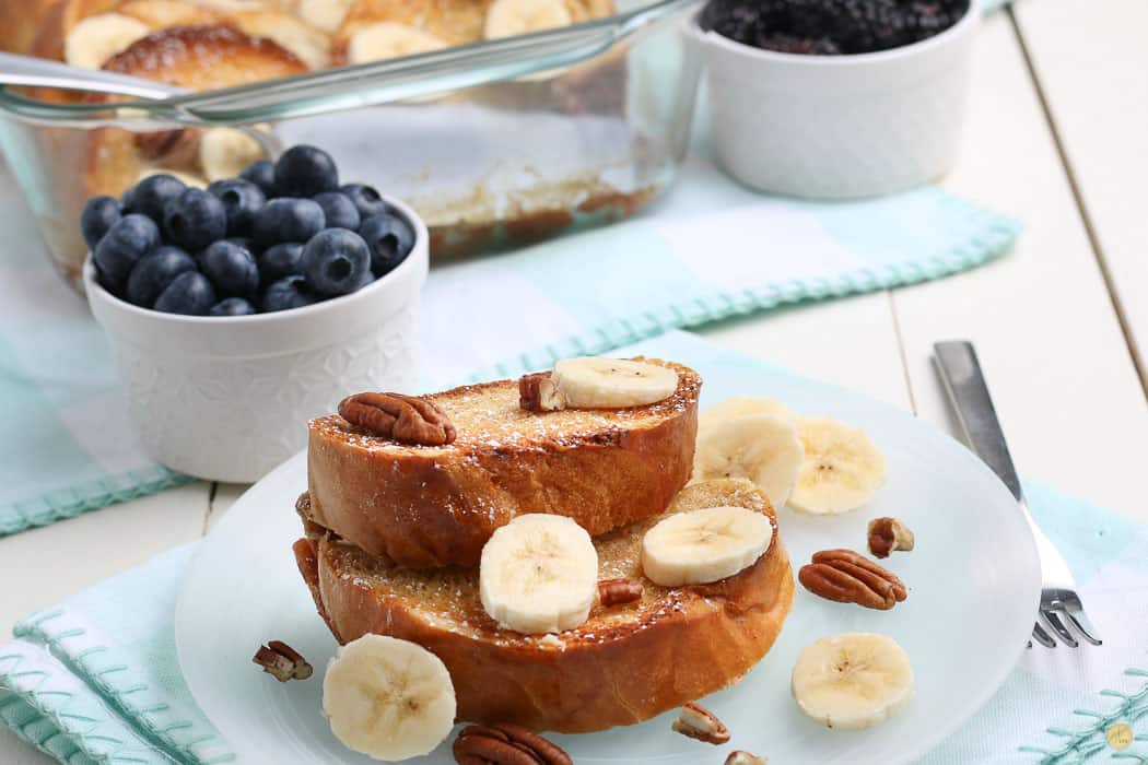 two slices of french toast with bananas on a blue plate