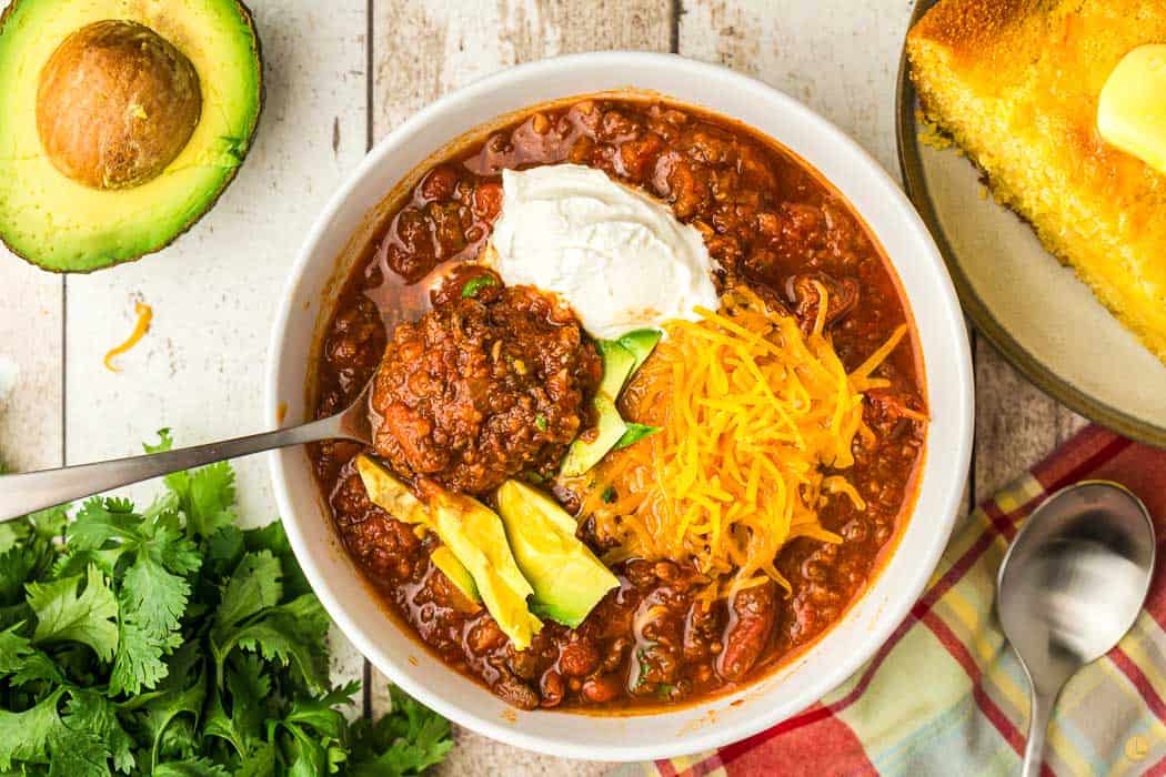 overhead picture of spoon in bowl of chili