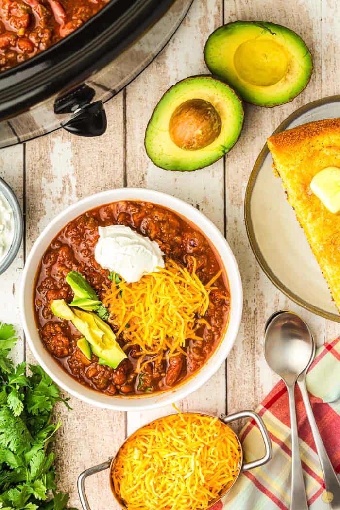 overhead picture of crock pot chili and toppings