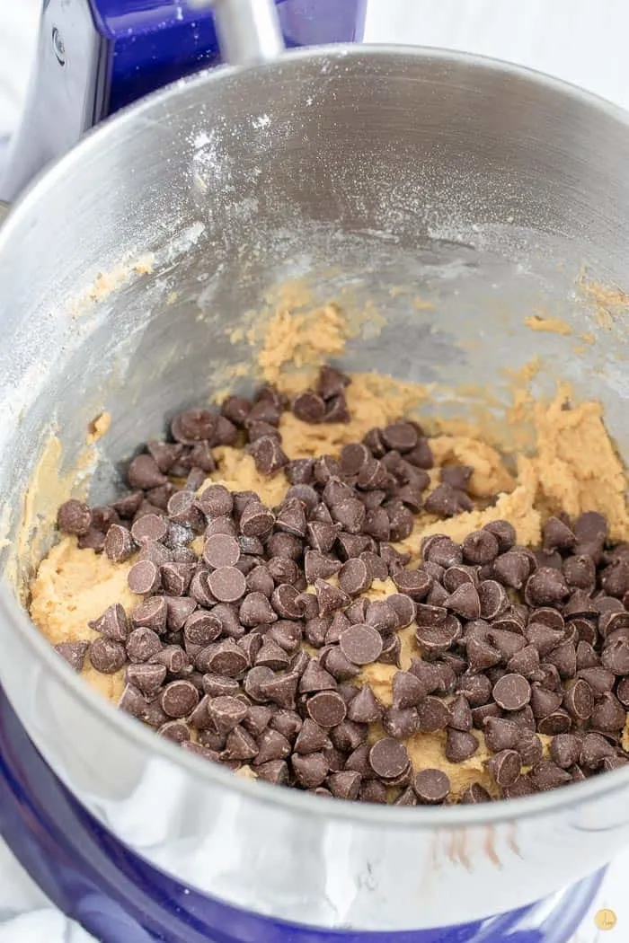 mixing bowl with cookie dough mix covered in chocolate chips