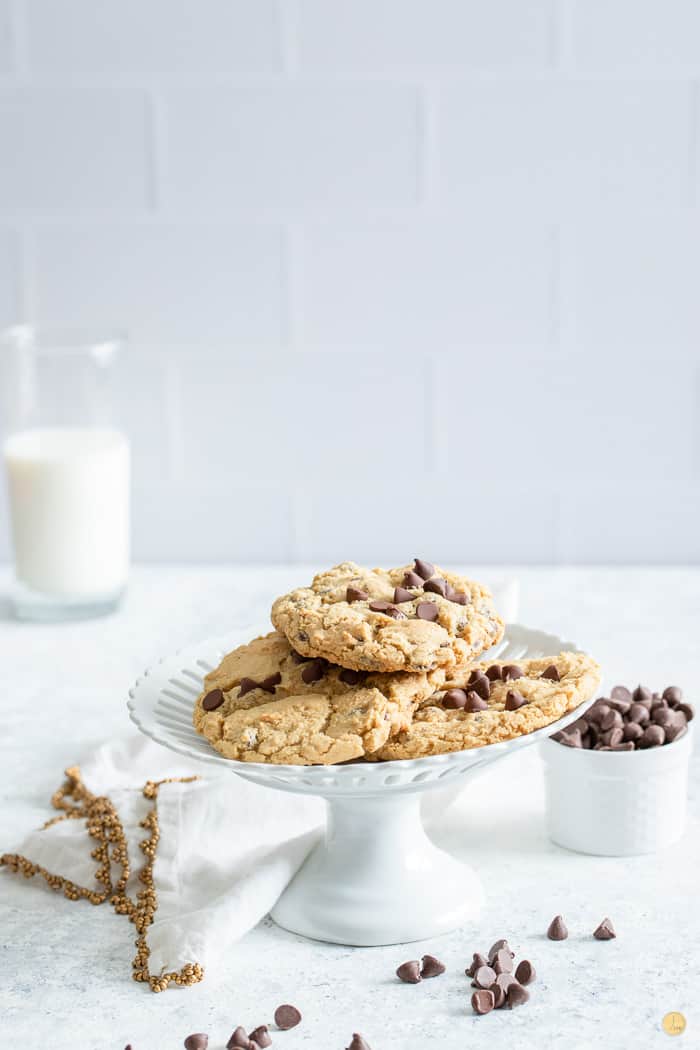 cookies on a white pie plate with milk in the background