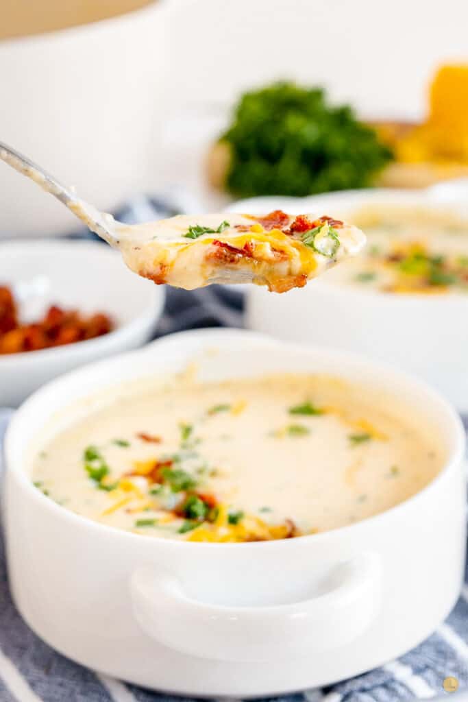 spoon of soup above bowl