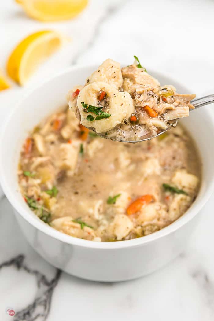 spoon of soup over a bowl