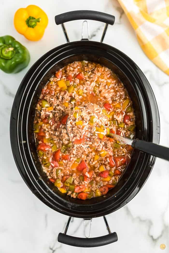 Soup in a pot with a ladle. Add brown sugar if it's too bitter.