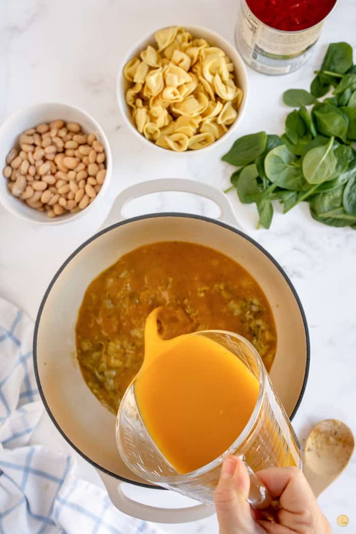 broth pouring into soup pot