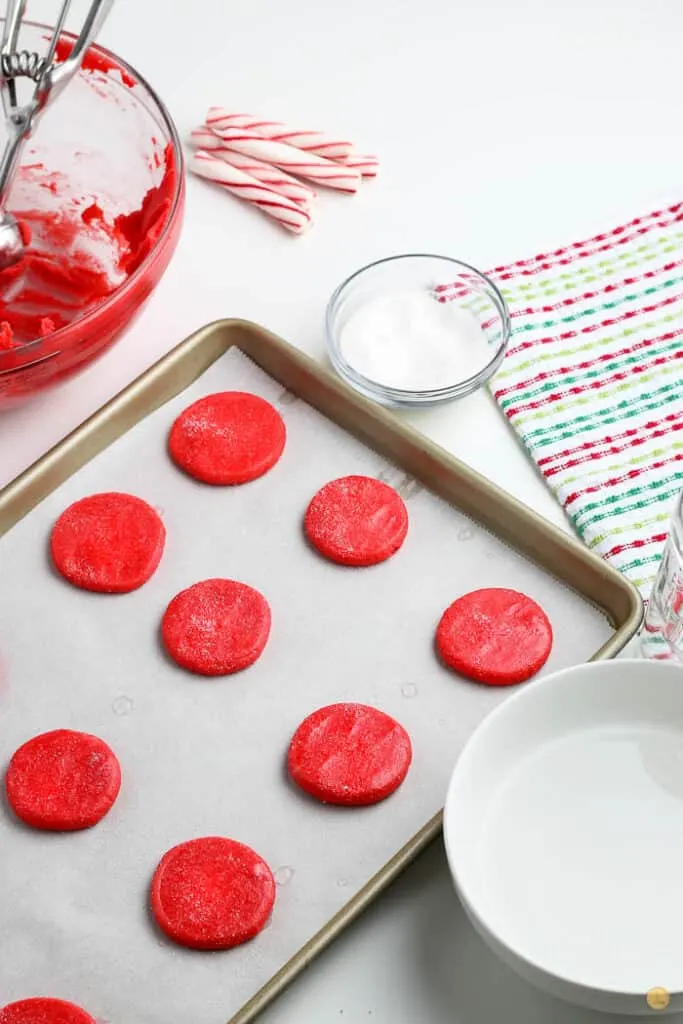 unbaked red cookies on baking sheet