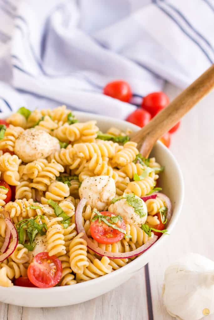 bowl of salad with wood spoon