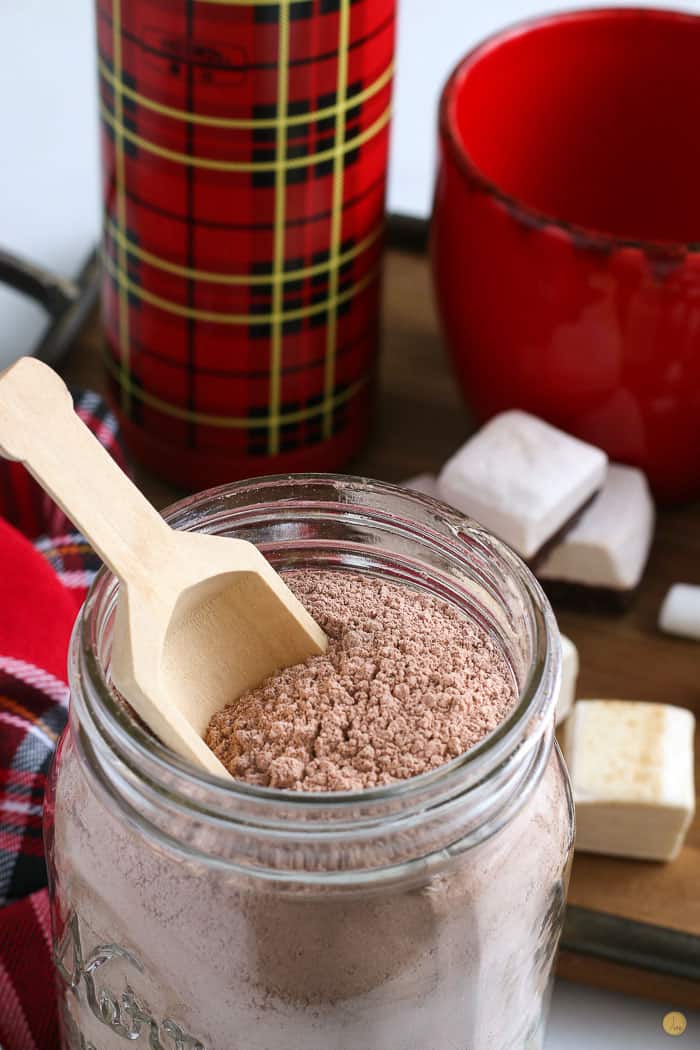 diy hot chocolate mix in a jar with a wood scoop