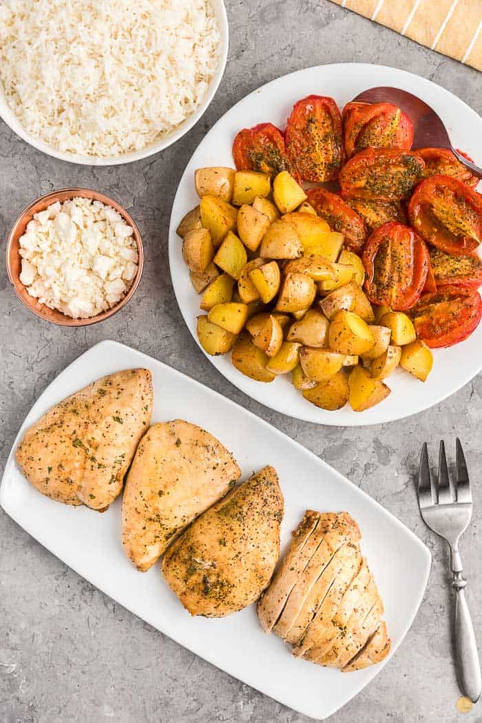 cooked chicken and tomatoes on platters