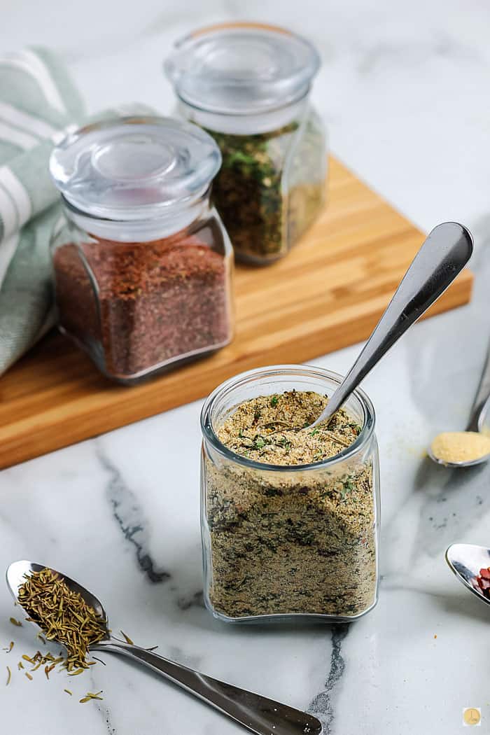 jar of seasoning with a spoon in it