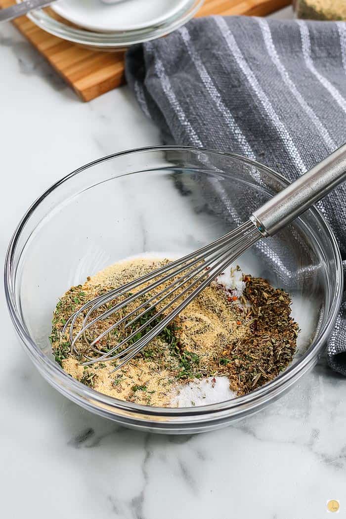 bowl of spices being mixed with a whisk
