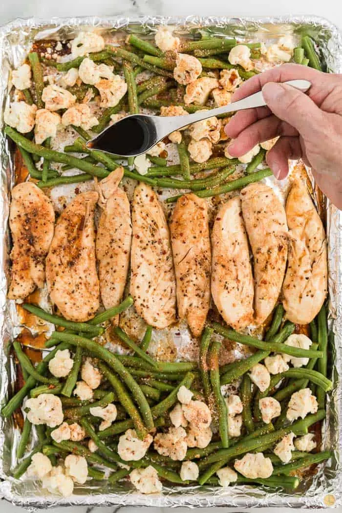 veggies and chicken on a baking sheet