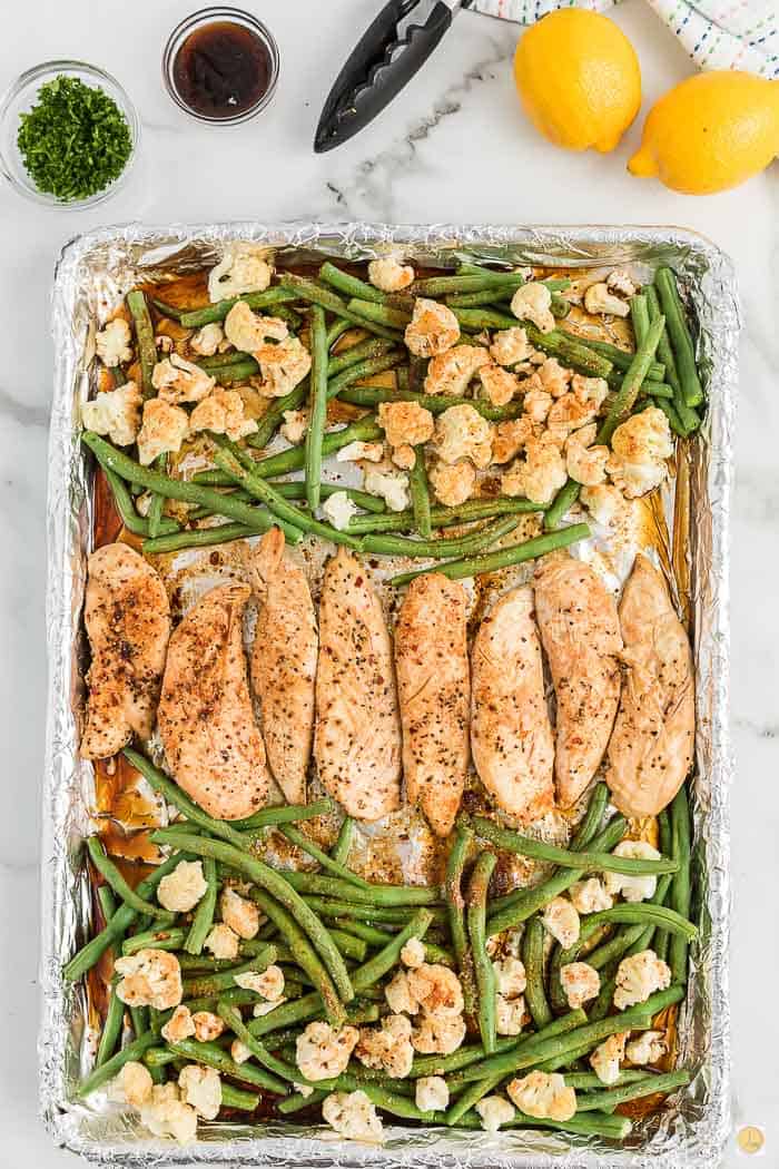 baked chicken and veggies on a sheet pan