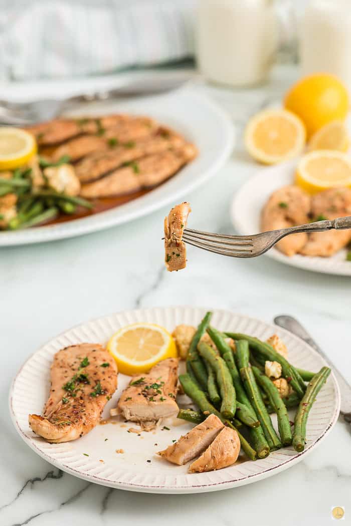 fork holding chicken and green bean