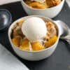 two bowls of peach cobbler