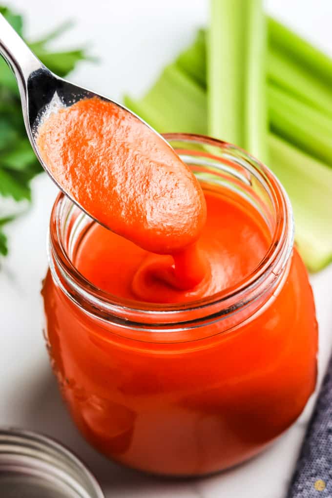 spoon in jar of sauce
