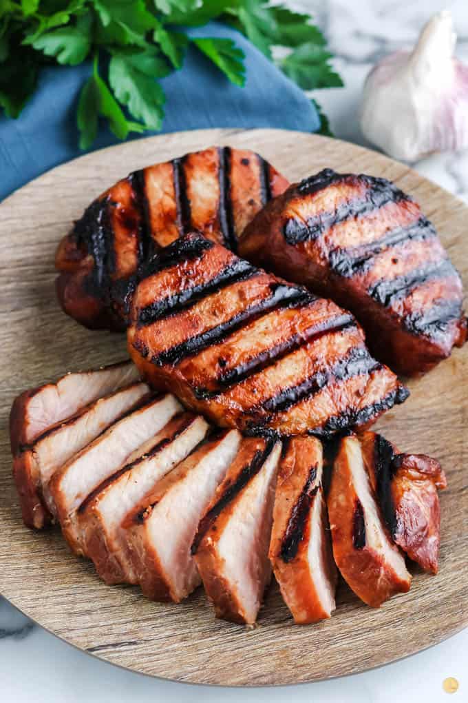 sliced pork on a wood plate