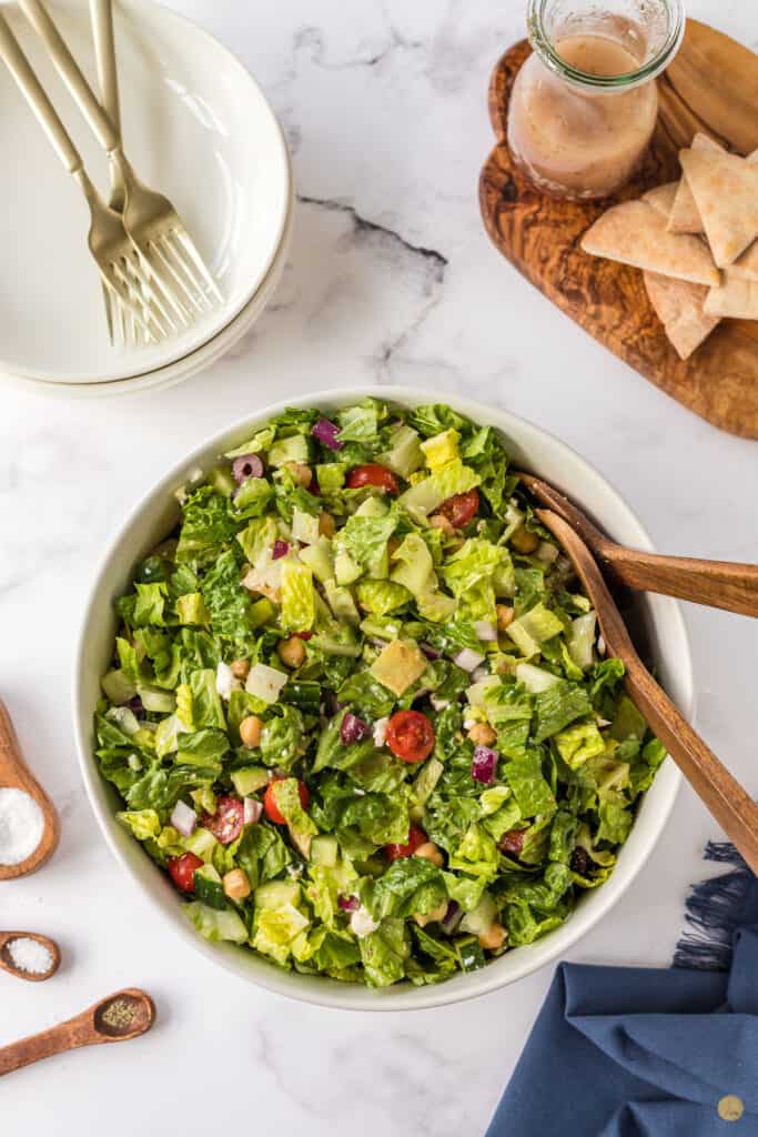 bowl of salad and stack of plates