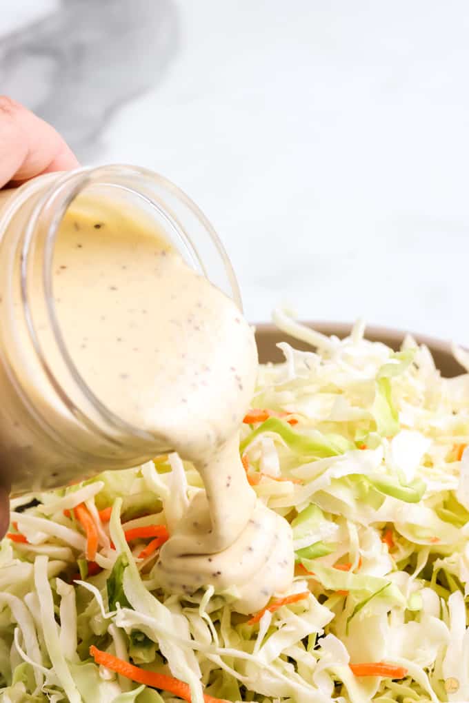 pouring dressing on salad