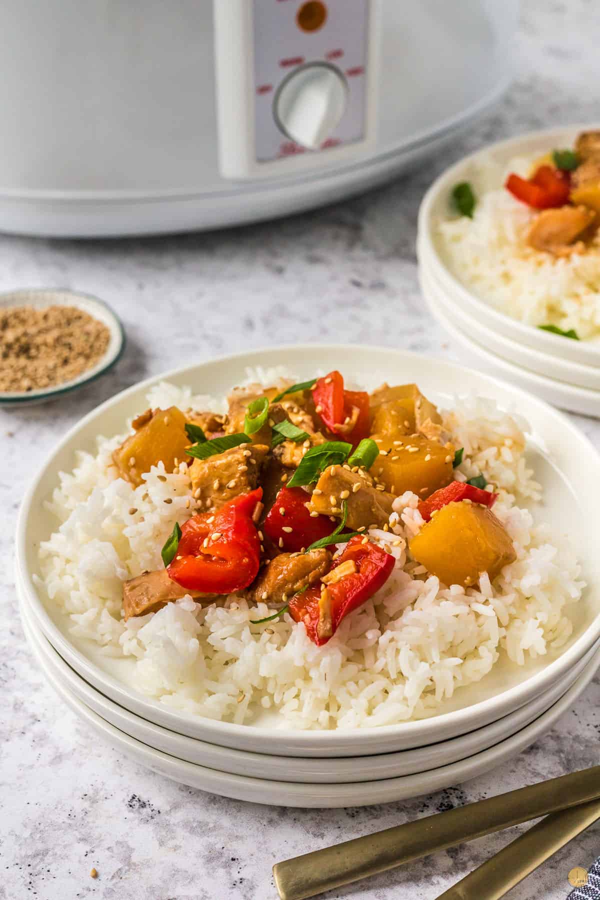 plate of chicken and pineapple over rice