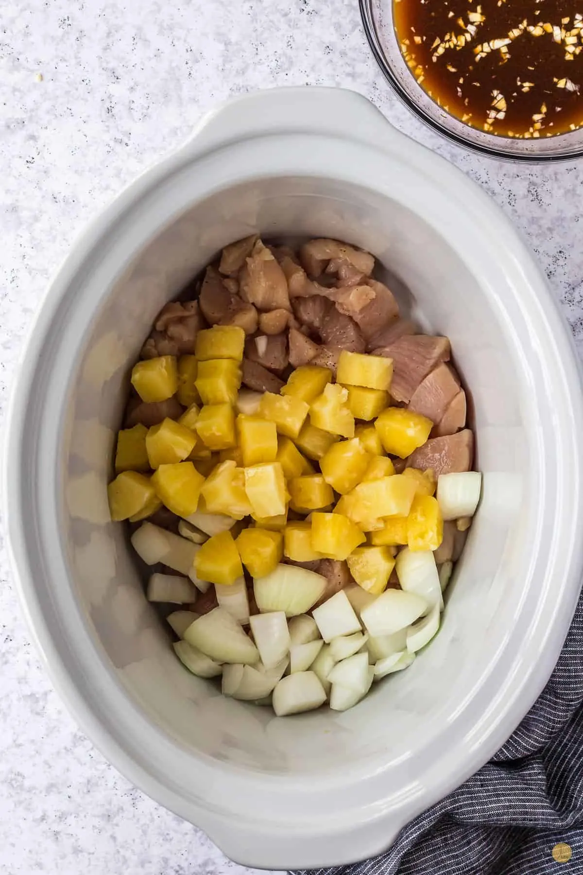 pineapple chicken and onion in a crock pot