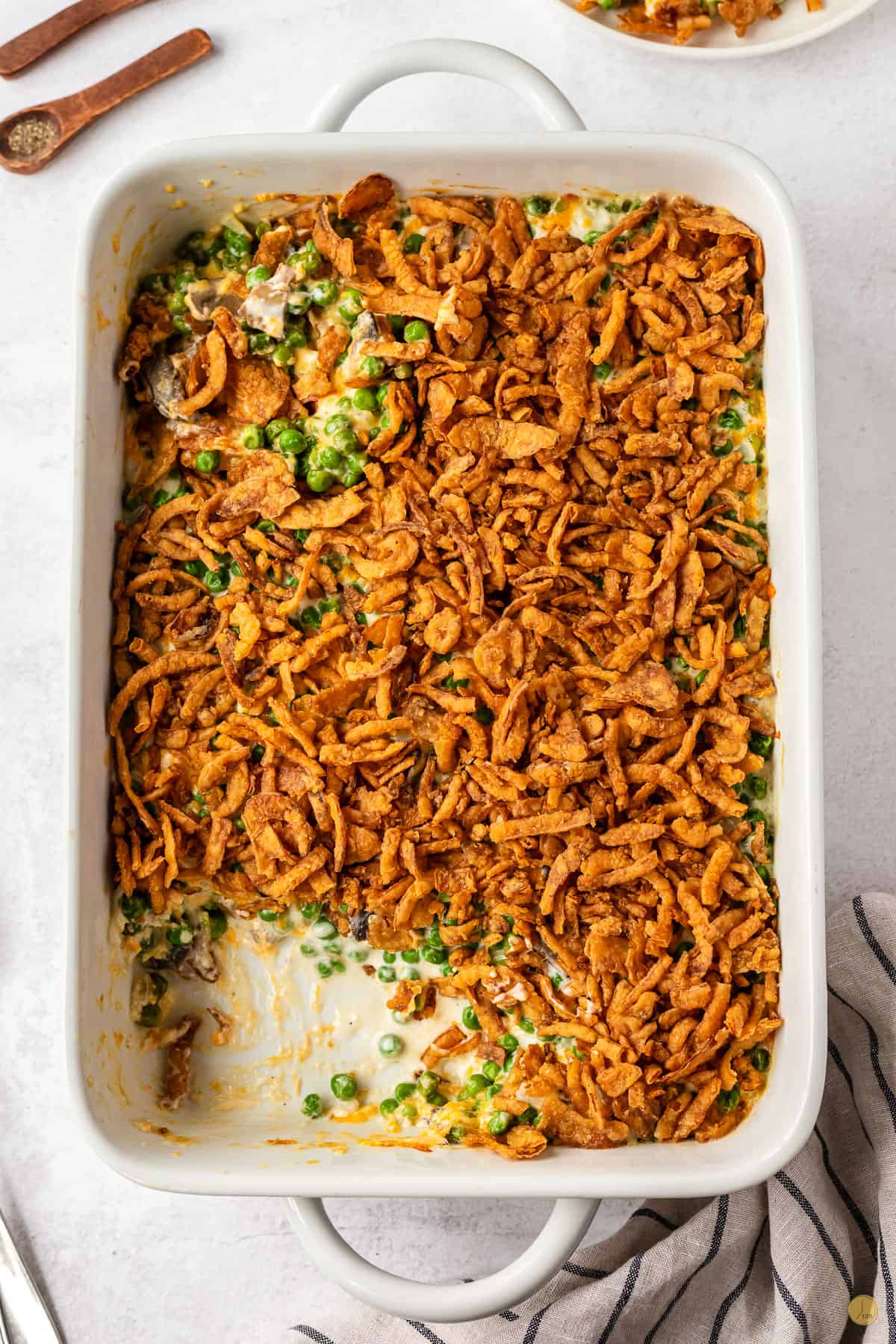 pea casserole in a dish with a scoop missing