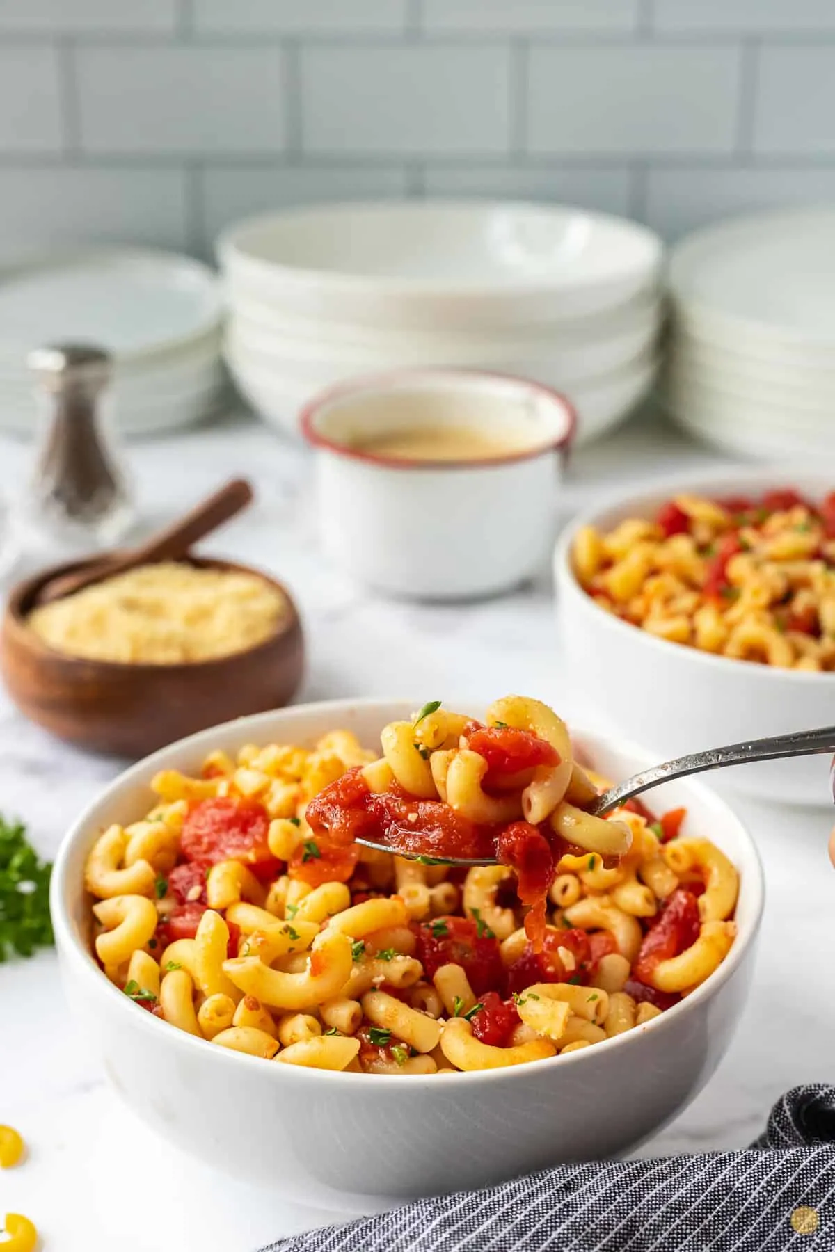 bowl of macaroni and tomatoes and a spoon