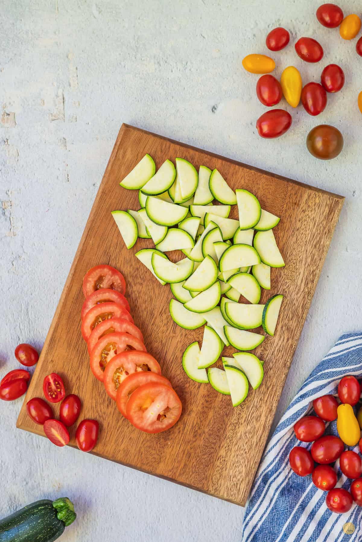 zucchini and tomatoes on a cutting board