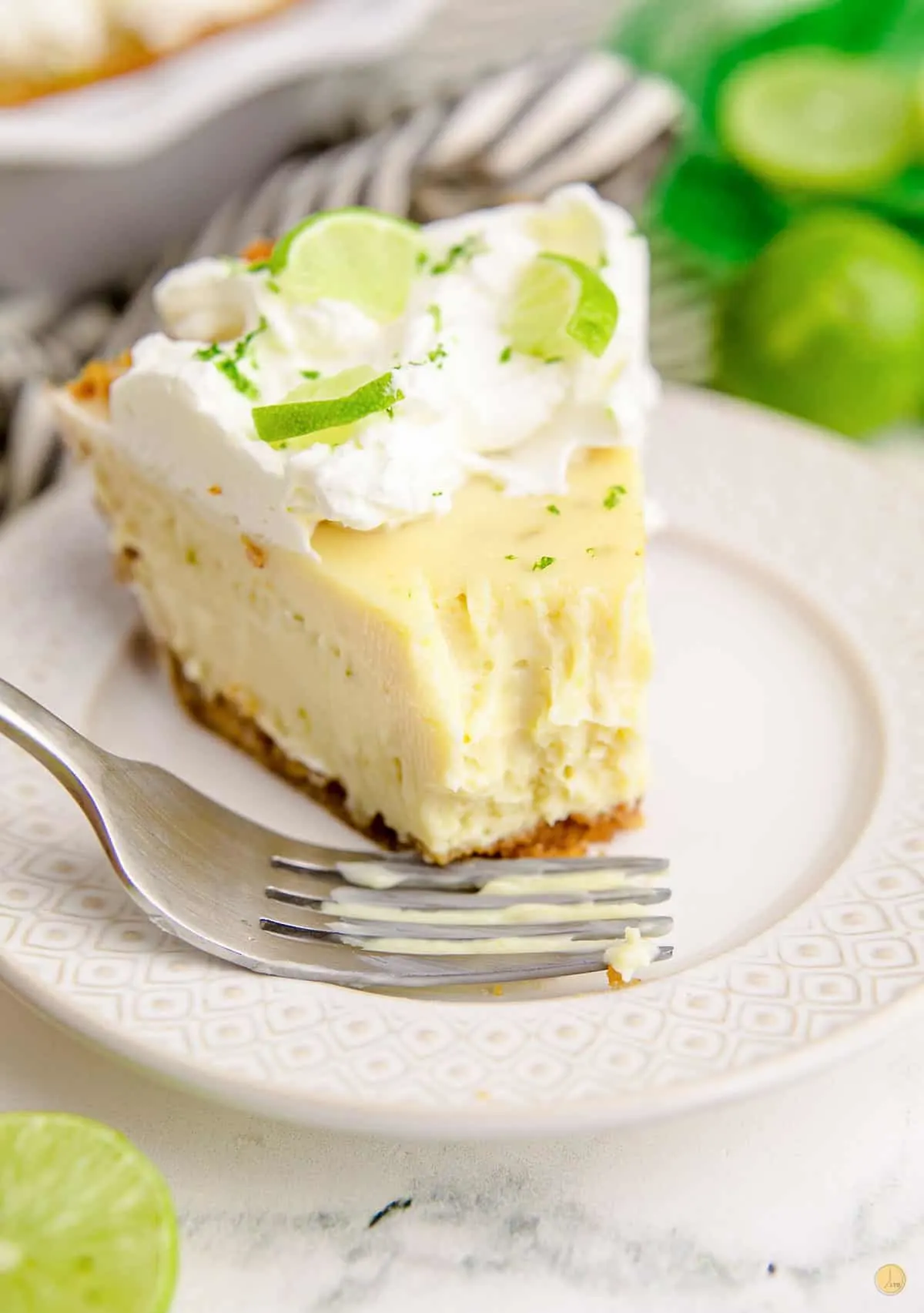 slice of key lime pie with bite missing