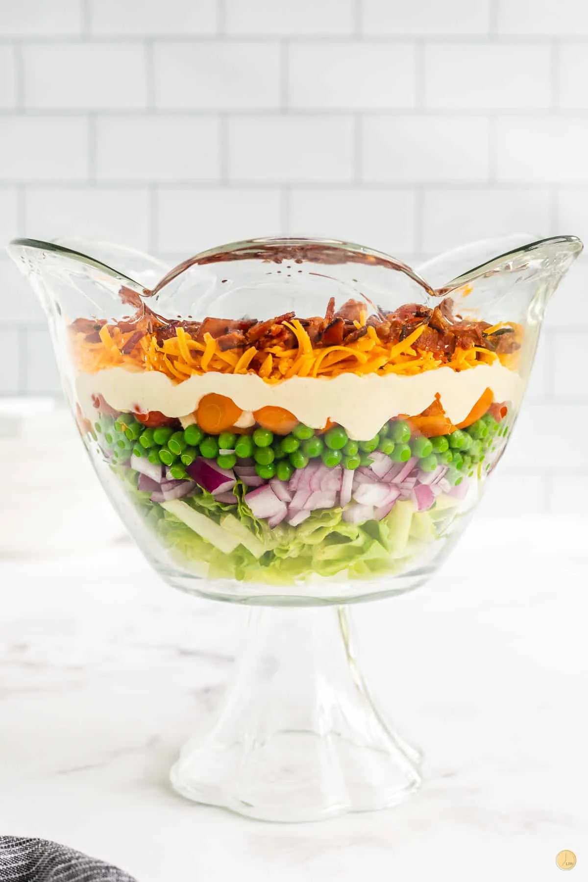 side view of a trifle bowl with salad