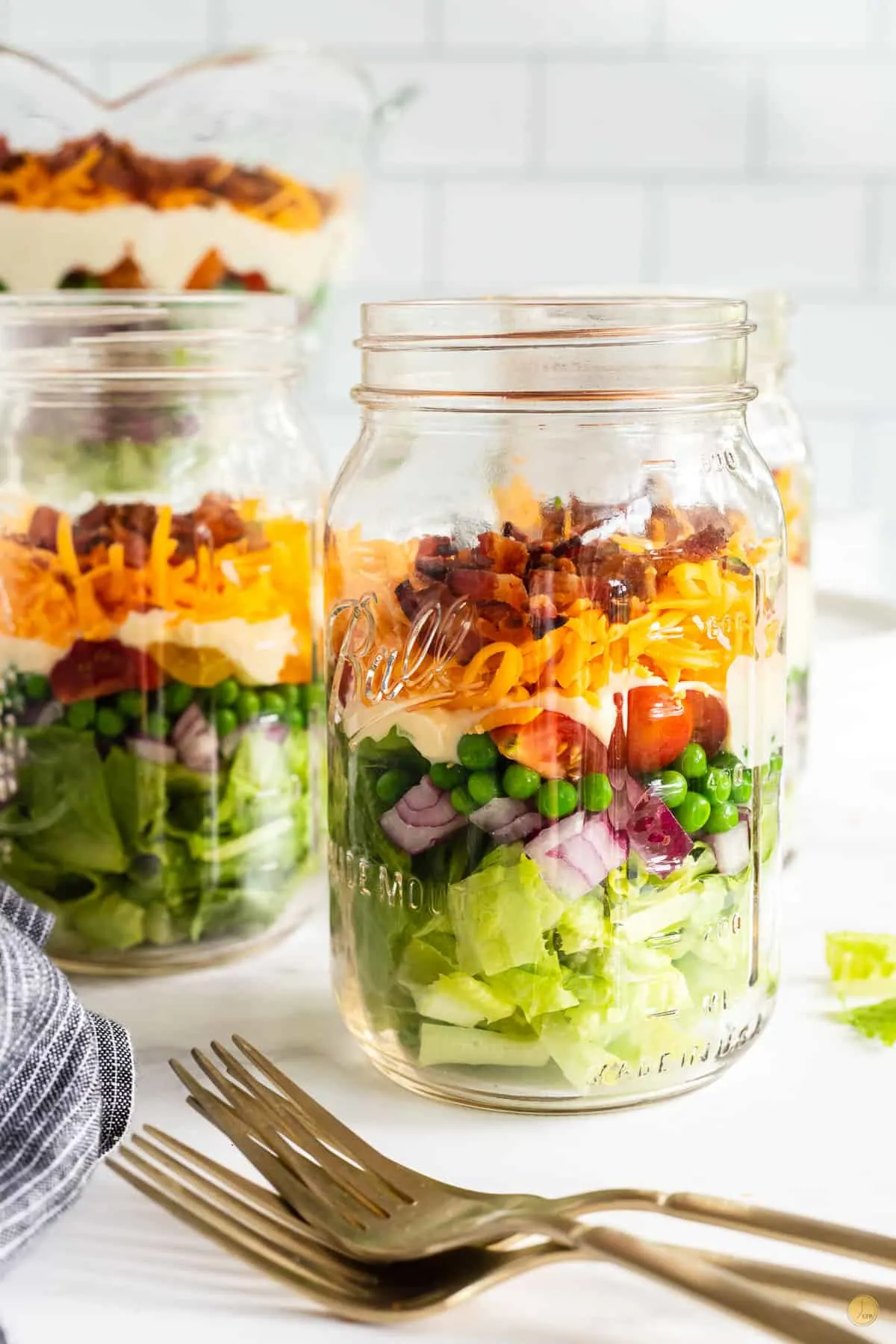 jars of 7 layer salad and forks