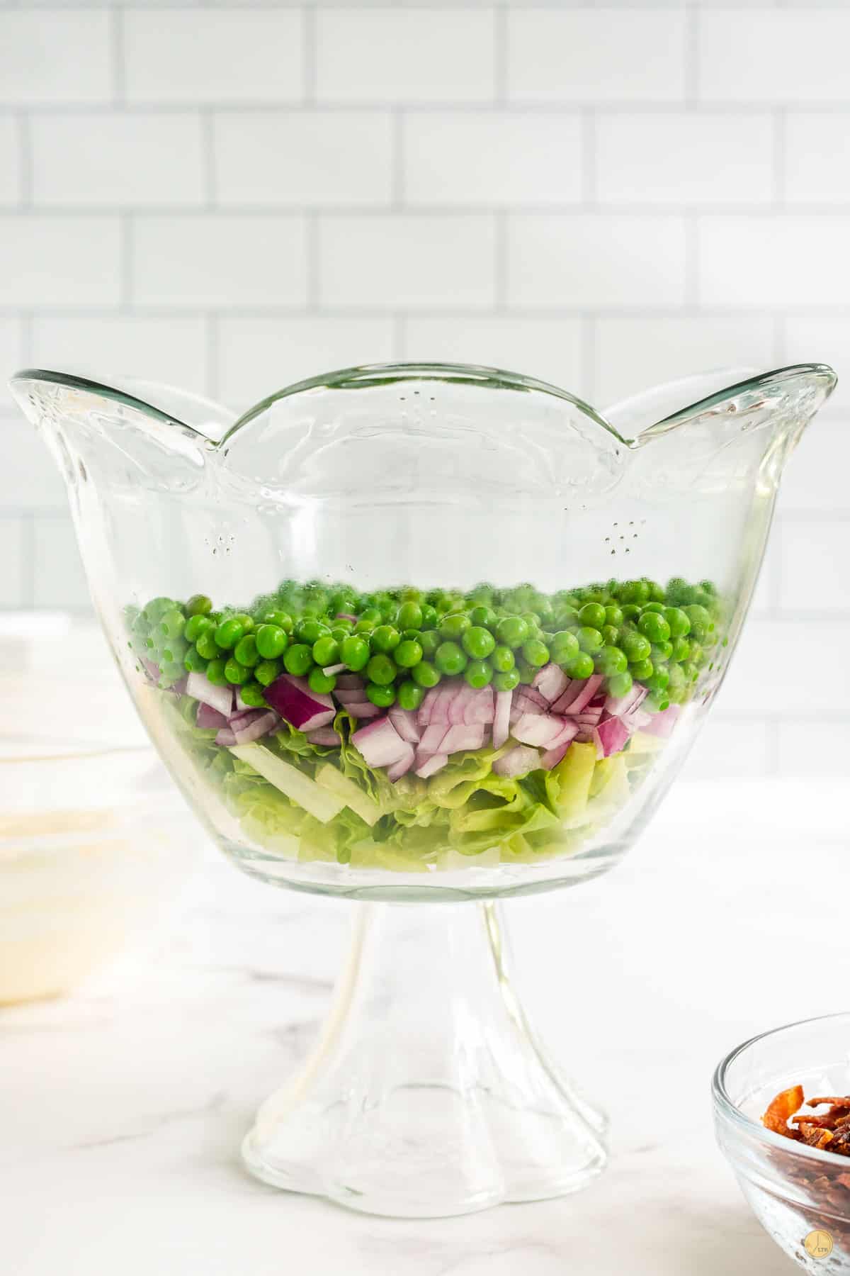 lettuce, peas, and onion in a bowl