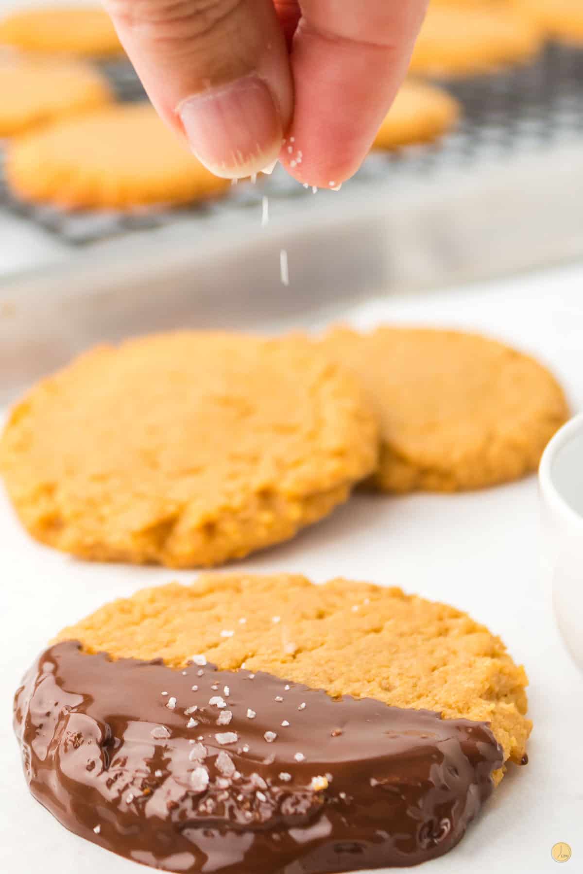 salt being sprinkled on a cookie