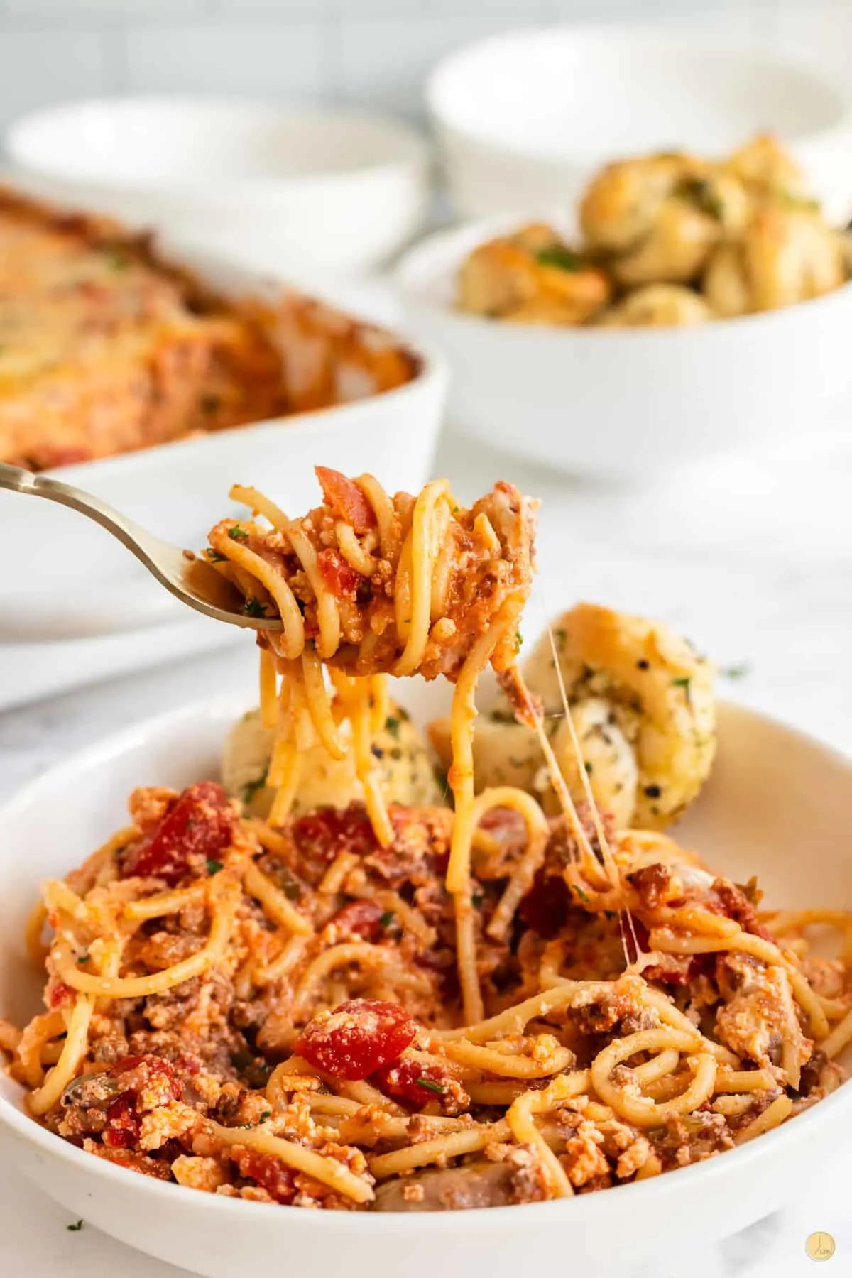 fork with bite of baked spaghetti casserole